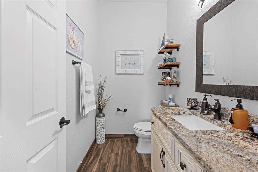 14173 Pullman Drive Spring Hill, FL 34609 - Photo 47 of 77 a bathroom with a granite countertop sink and a mirror