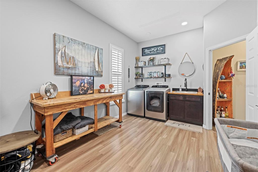 14173 Pullman Drive Spring Hill, FL 34609 - Photo 48 of 77 a kitchen with stainless steel appliances granite countertop a stove a sink dishwasher and a refrigerator with wooden floor