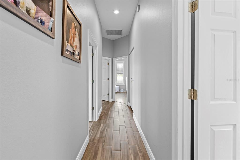 14173 Pullman Drive Spring Hill, FL 34609 - Photo 49 of 77 a view of a hallway with wooden floor and staircase