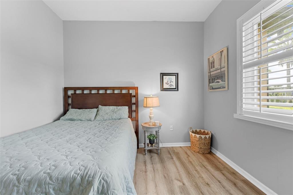 14173 Pullman Drive Spring Hill, FL 34609 - Photo 53 of 77 a bedroom with a bed and wooden floor