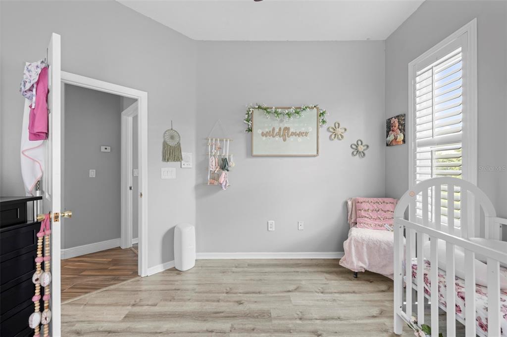 14173 Pullman Drive Spring Hill, FL 34609 - Photo 57 of 77 a view of an empty room with window and wooden floor
