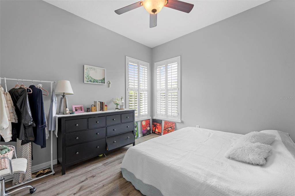 14173 Pullman Drive Spring Hill, FL 34609 - Photo 58 of 77 a bedroom with a bed and a chandelier