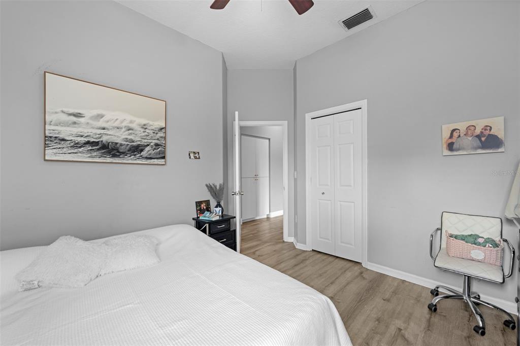 14173 Pullman Drive Spring Hill, FL 34609 - Photo 59 of 77 a bedroom with a bed and a painting on the wall