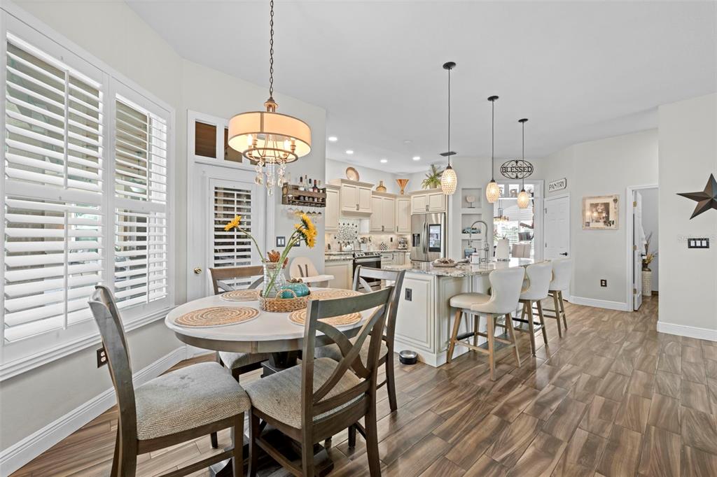 14173 Pullman Drive Spring Hill, FL 34609 - Photo 64 of 77 a view of a dining room with furniture and wooden floor