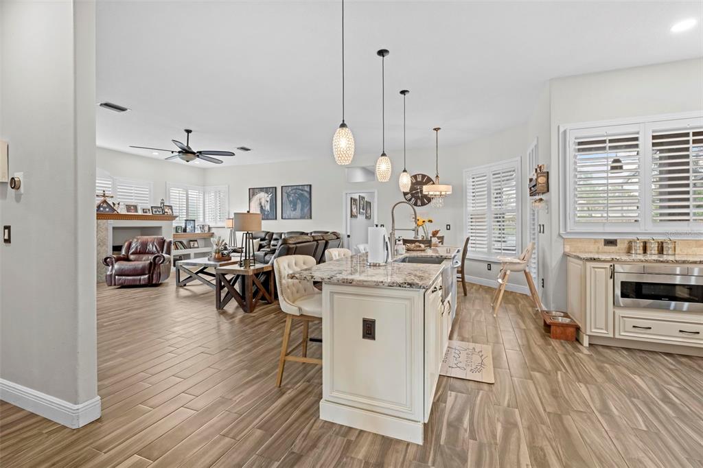 14173 Pullman Drive Spring Hill, FL 34609 - Photo 10 of 77 a view of a living room kitchen and a wooden floor
