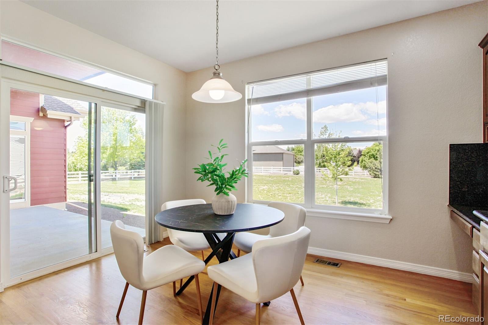 16283 Olive Way Brighton, CO 80602 - Photo 15 of 33 a view of a dining room with furniture window and outside view
