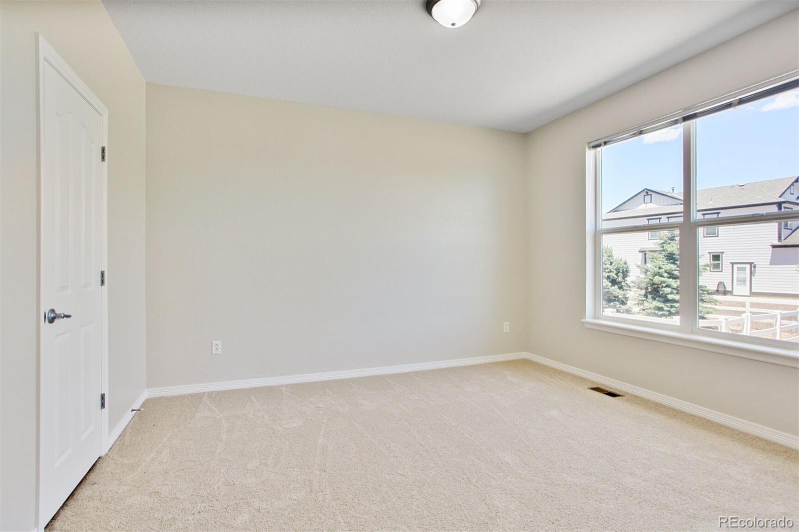 16283 Olive Way Brighton, CO 80602 - Photo 22 of 33 an empty room with a window