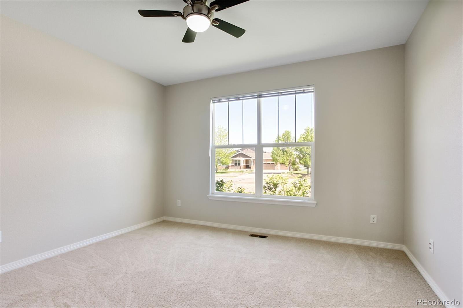 16283 Olive Way Brighton, CO 80602 - Photo 23 of 33 an empty room with a window and a fan