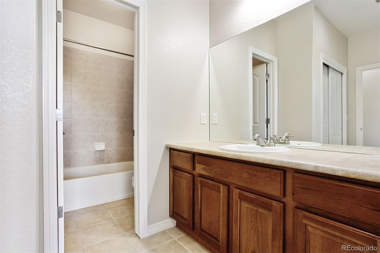 16283 Olive Way Brighton, CO 80602 - Photo 26 of 33 a bathroom with a sink and a mirror