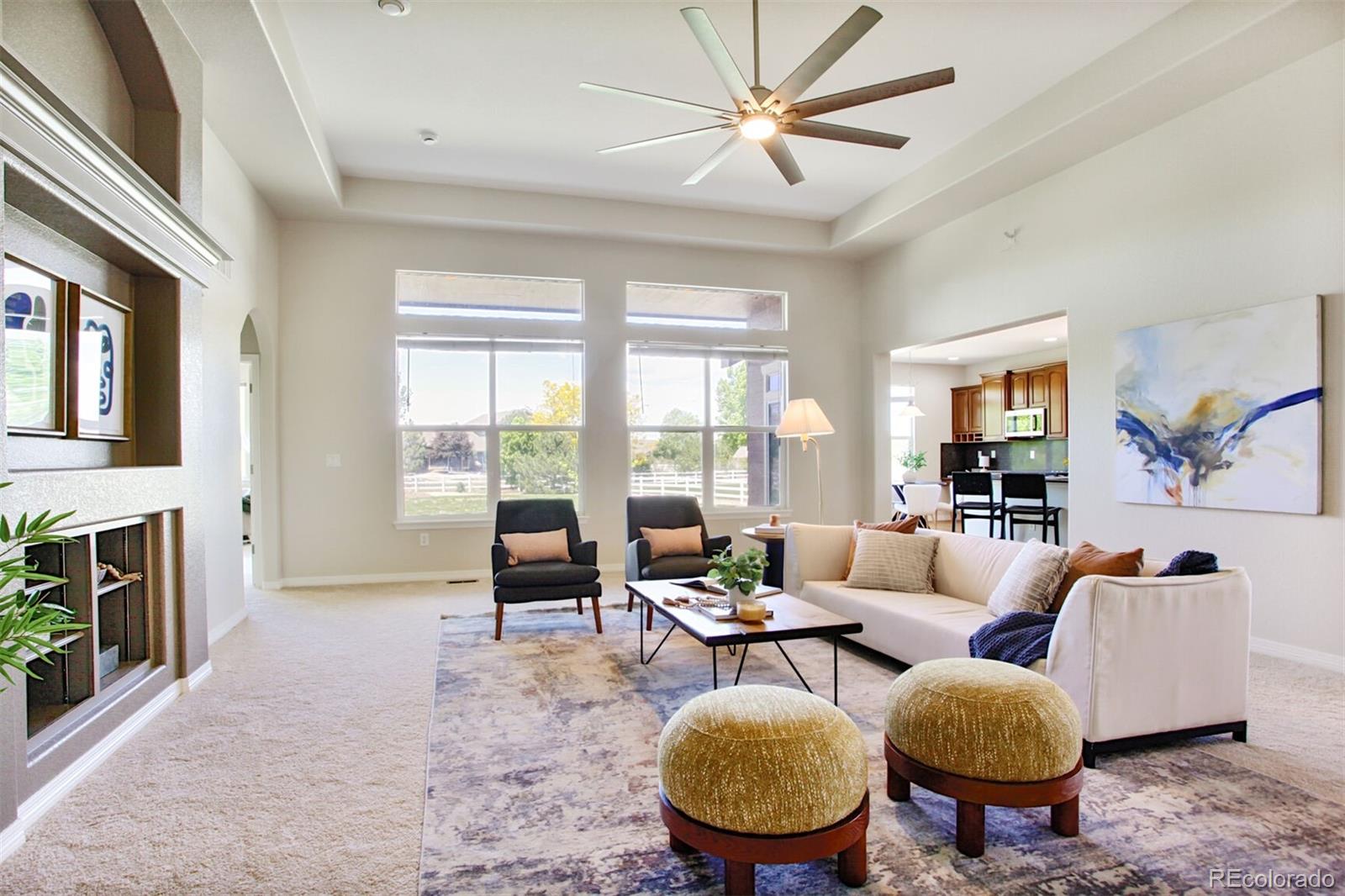 16283 Olive Way Brighton, CO 80602 - Photo 10 of 33 a living room with fireplace furniture and a large window
