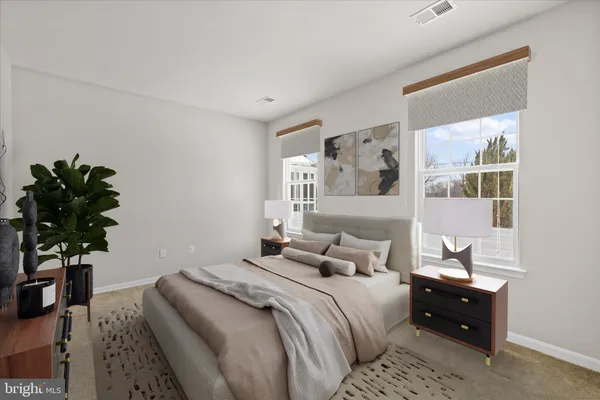 a bedroom with a bed and a potted plant