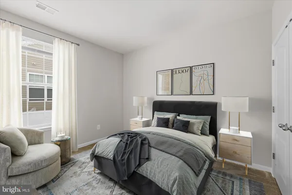 a bedroom with a bed couch and window