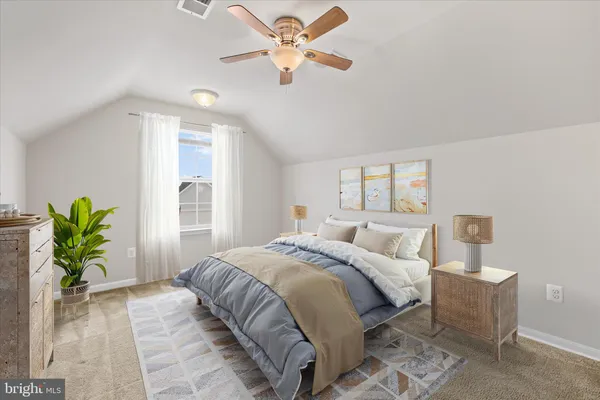 a bedroom with a bed a chandelier and a potted plant