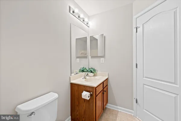 a bathroom with a sink a toilet and mirror