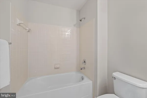 a white bath tub sitting next to a white toilet
