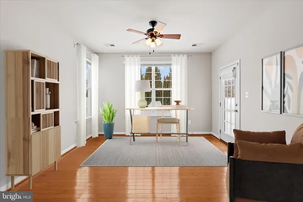a living room with furniture window and wooden floor