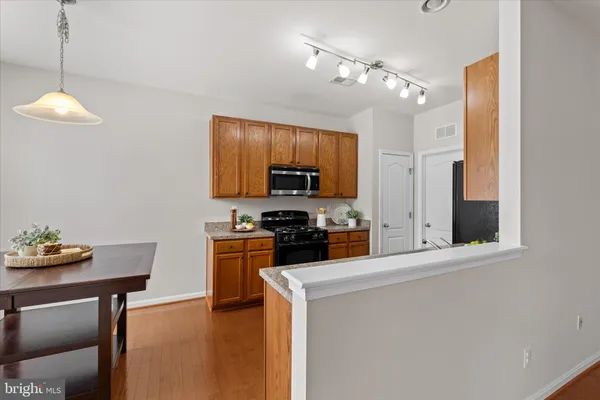a kitchen with stainless steel appliances a stove refrigerator sink and microwave