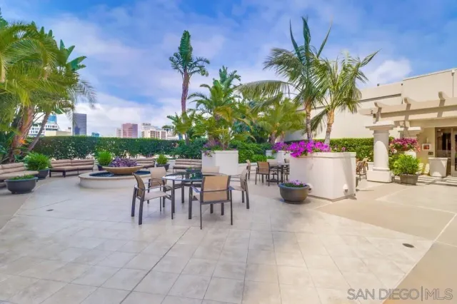 a view of a patio with a table and chairs and potted plants