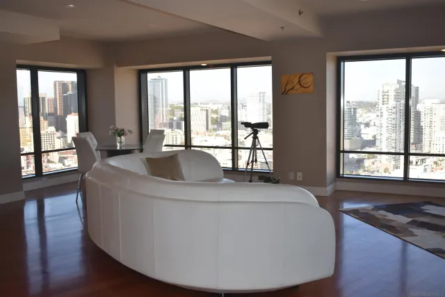 a living room with furniture and large windows