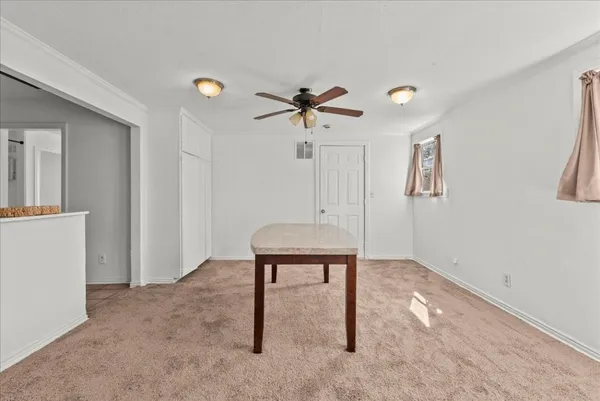 an empty room with fan and a ceiling fan