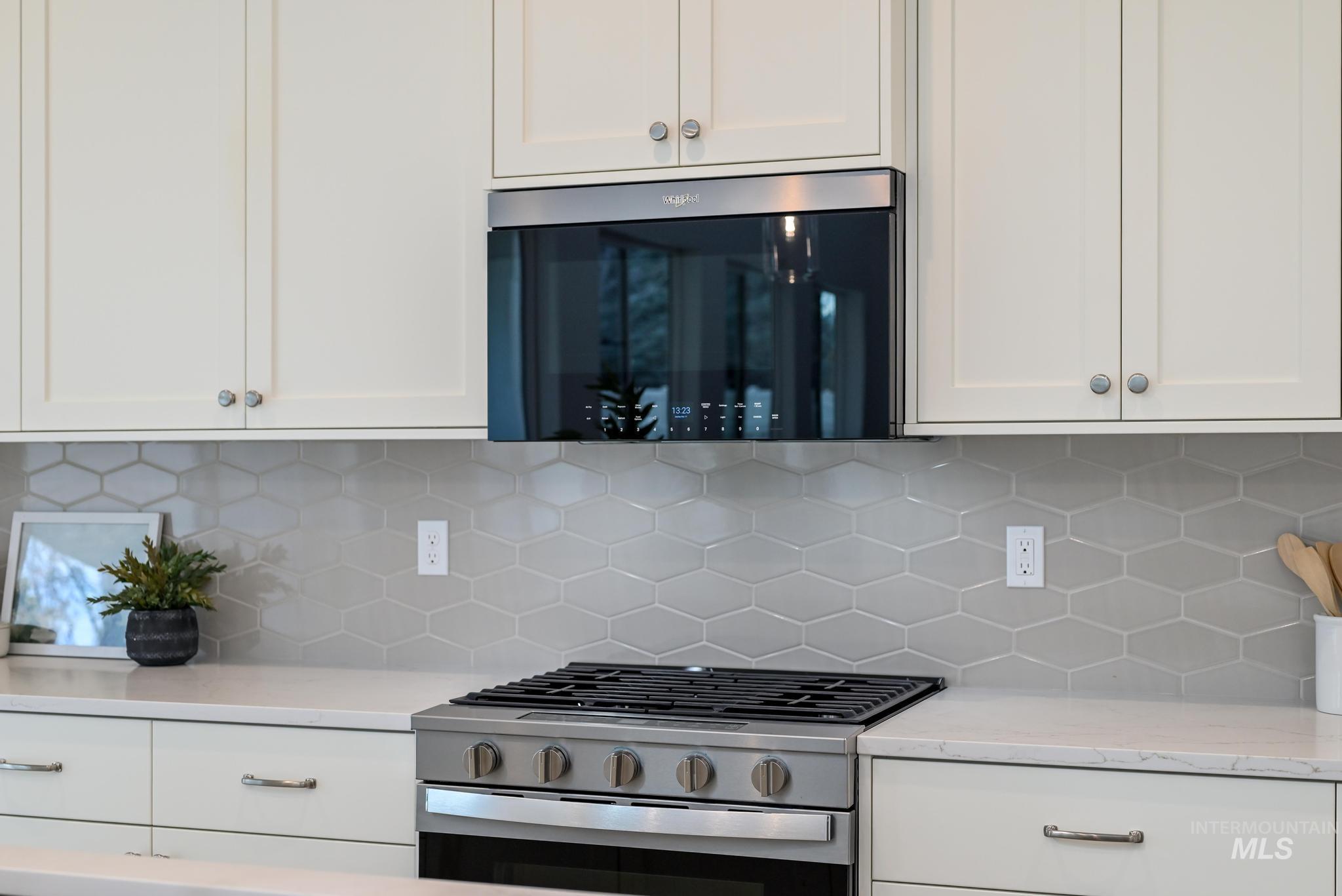 2005 North Spg Crk Avenue Middleton, ID 83644 - Photo 13 of 45 Kitchen featuring white cabinets, stainless steel appliances, and tasteful backsplash