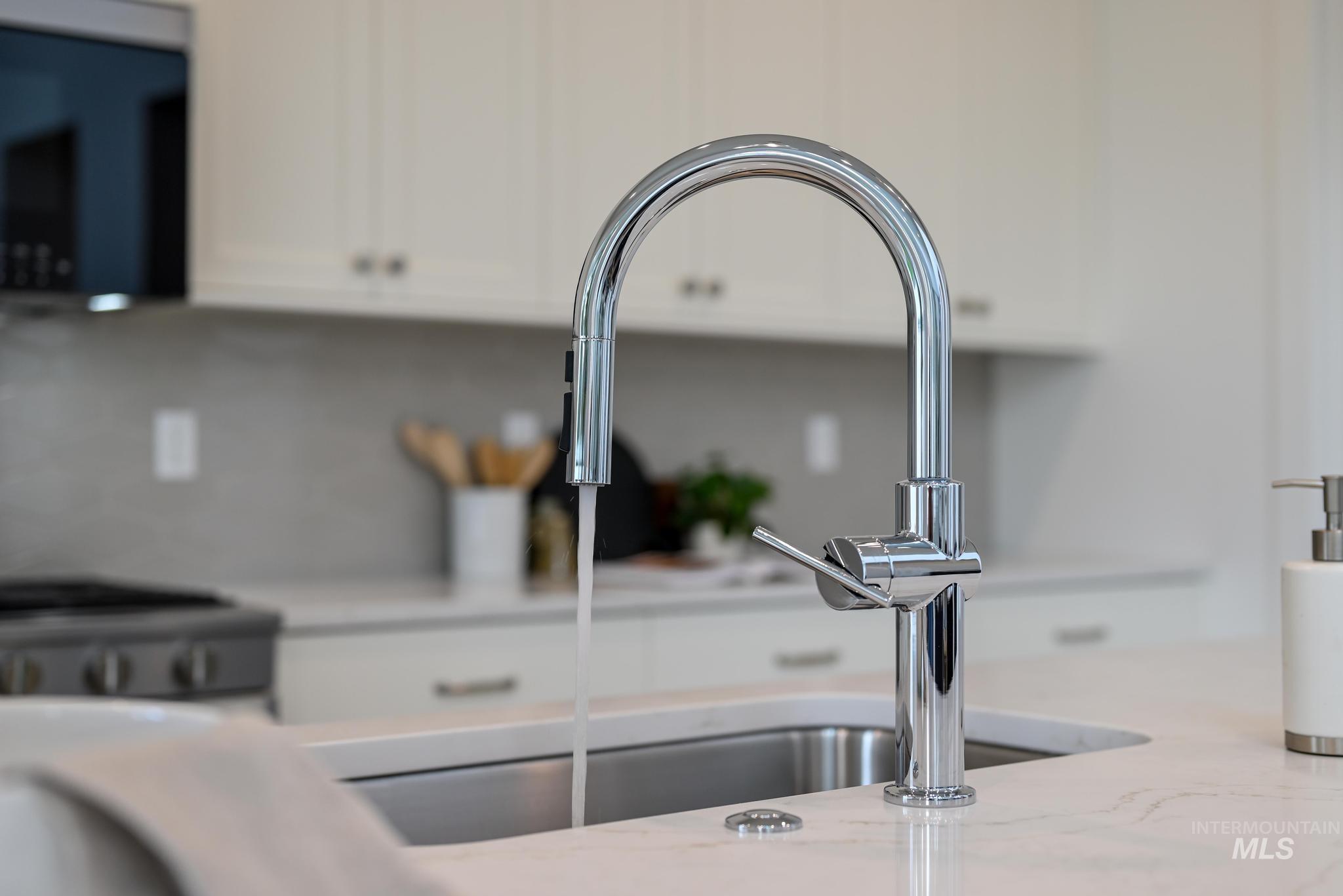 2005 North Spg Crk Avenue Middleton, ID 83644 - Photo 15 of 45 Kitchen view of white cabinets, stainless steel stove, and light stone counters