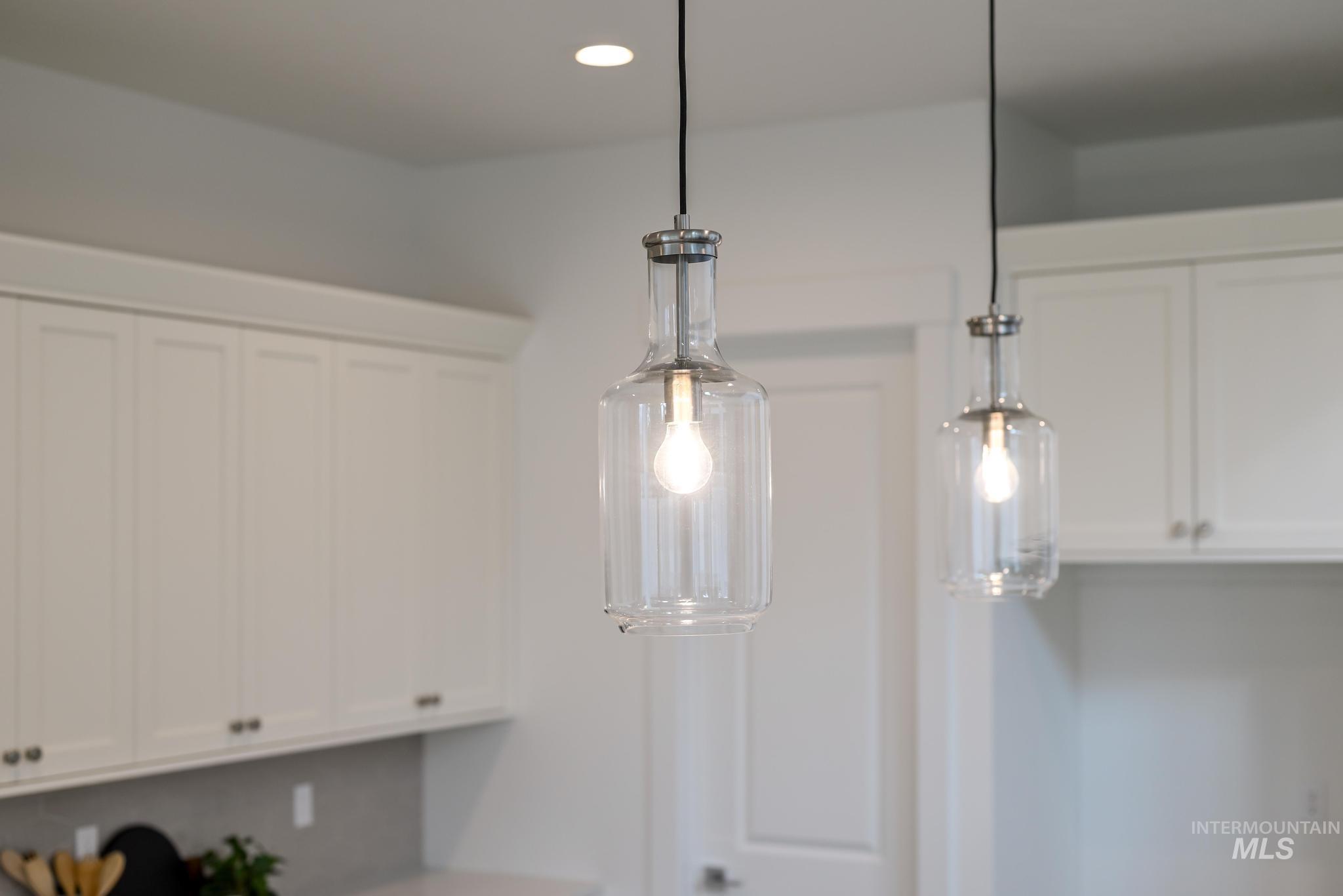 2005 North Spg Crk Avenue Middleton, ID 83644 - Photo 17 of 45 Detailed view of white cabinetry, pendant lighting, recessed lighting, and light countertops