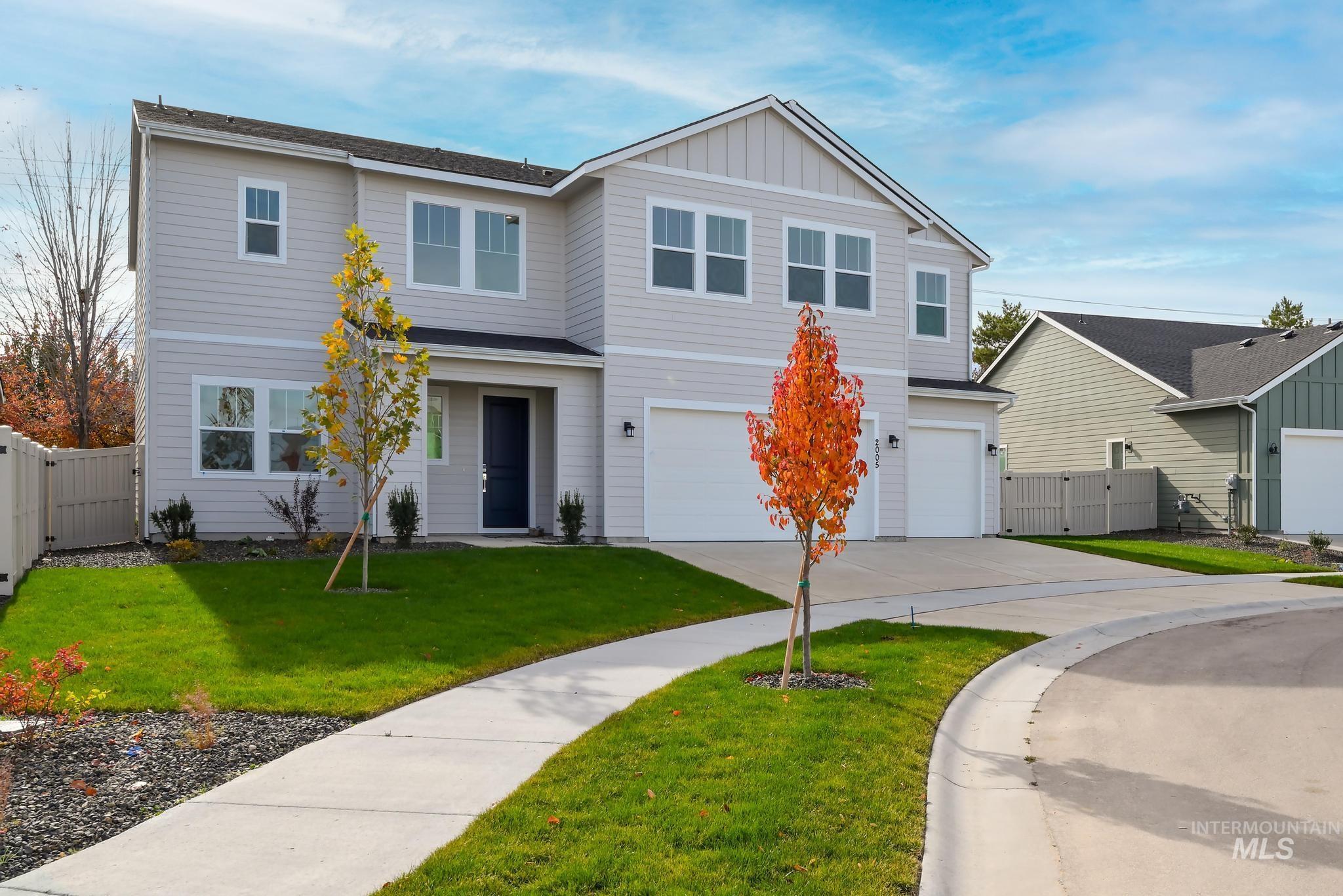 2005 North Spg Crk Avenue Middleton, ID 83644 - Photo 2 of 45 View of front facade with driveway, an attached garage, and board and batten siding