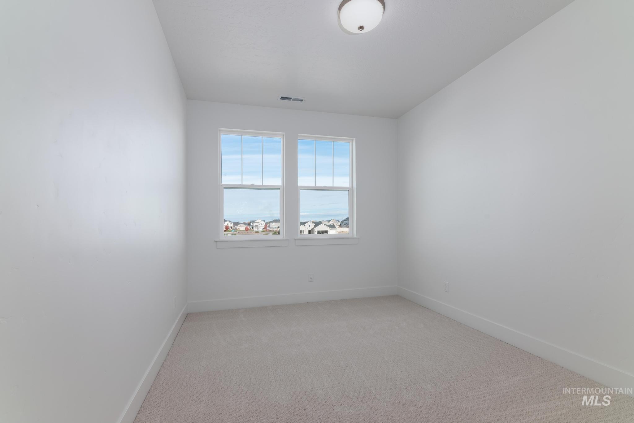 2005 North Spg Crk Avenue Middleton, ID 83644 - Photo 27 of 45 Unfurnished room with light colored carpet and baseboards