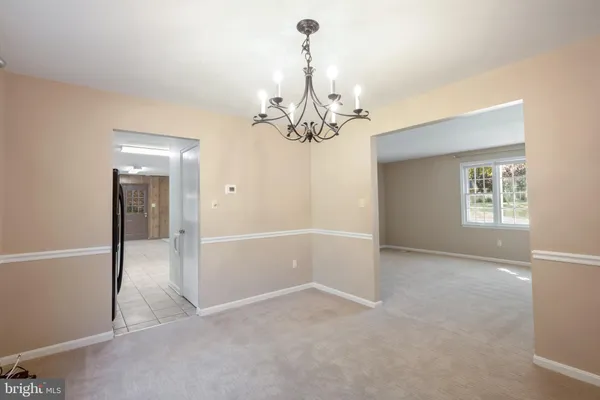 a large kitchen with stainless steel appliances a sink and cabinets