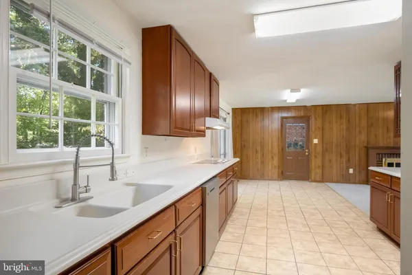a spacious bathroom with a granite countertop sink and a mirror