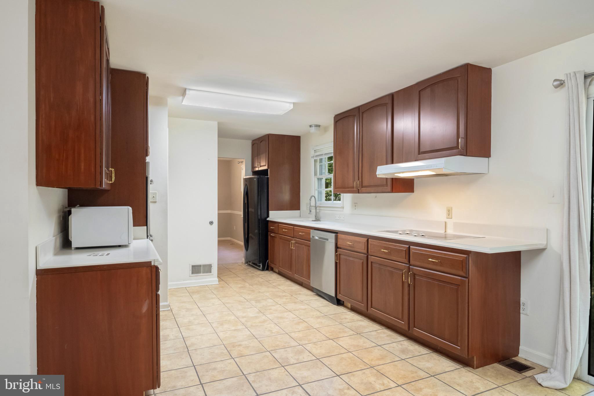 7223 Reservation Drive Springfield, VA 22153 - Photo 14 of 40 Modern kitchen with warm wood cabinetry.
