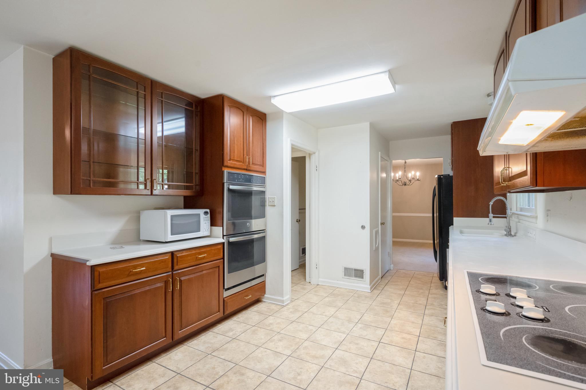 7223 Reservation Drive Springfield, VA 22153 - Photo 16 of 40 Modern kitchen with warm wood accents.