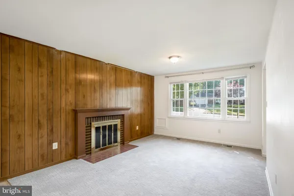 a view of a kitchen with a sink a fireplace and a window