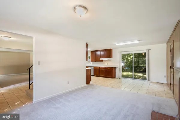 a view of an empty room with a fireplace and a window