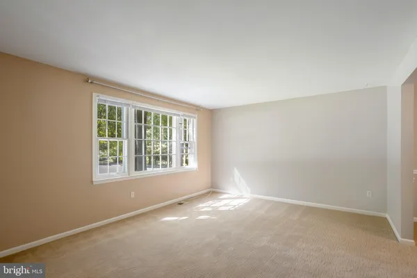 an empty room with windows and entrance