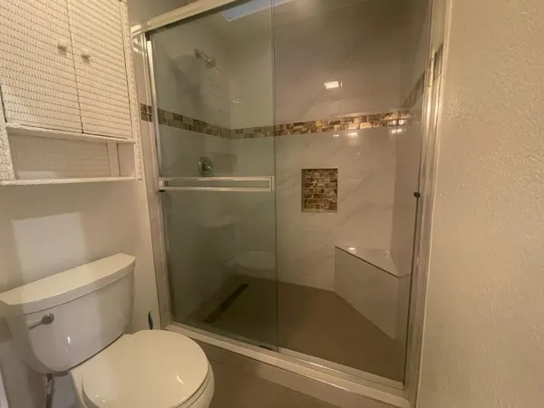 a bathroom with a shower and toilet