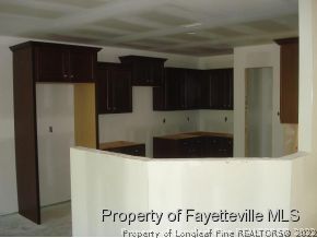 5636 Nessee Street Fayetteville, NC 28314 - Photo 3 of 4 a kitchen with stainless steel appliances a refrigerator and a stove