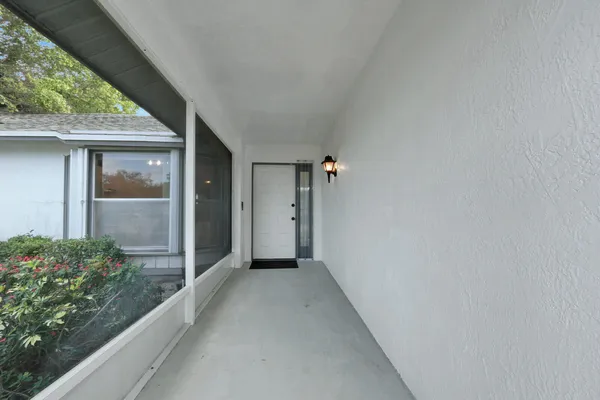a kitchen with white cabinets and black appliances