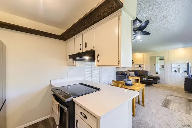 a kitchen with a sink dishwasher a stove and a refrigerator with wooden floor