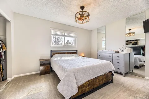 a bedroom with a bed and a chandelier