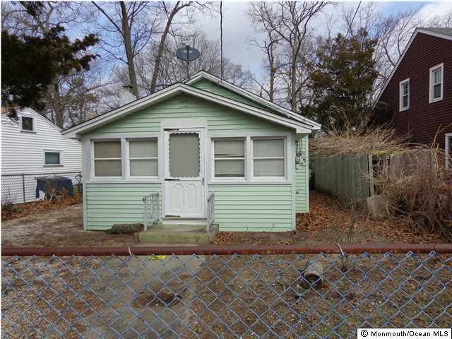 108 Edwards Road Brick, NJ 08723 - Photo 1 of 3 a small white house with a white roof and table and chairs next to window