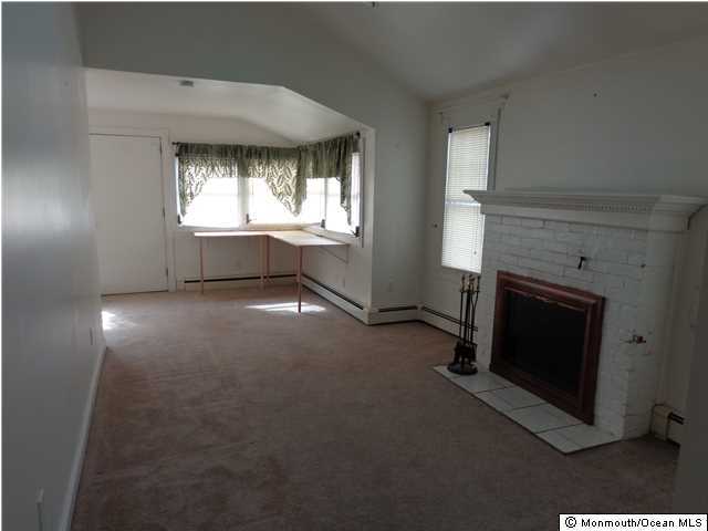 108 Edwards Road Brick, NJ 08723 - Photo 2 of 3 a view of empty room with a fireplace