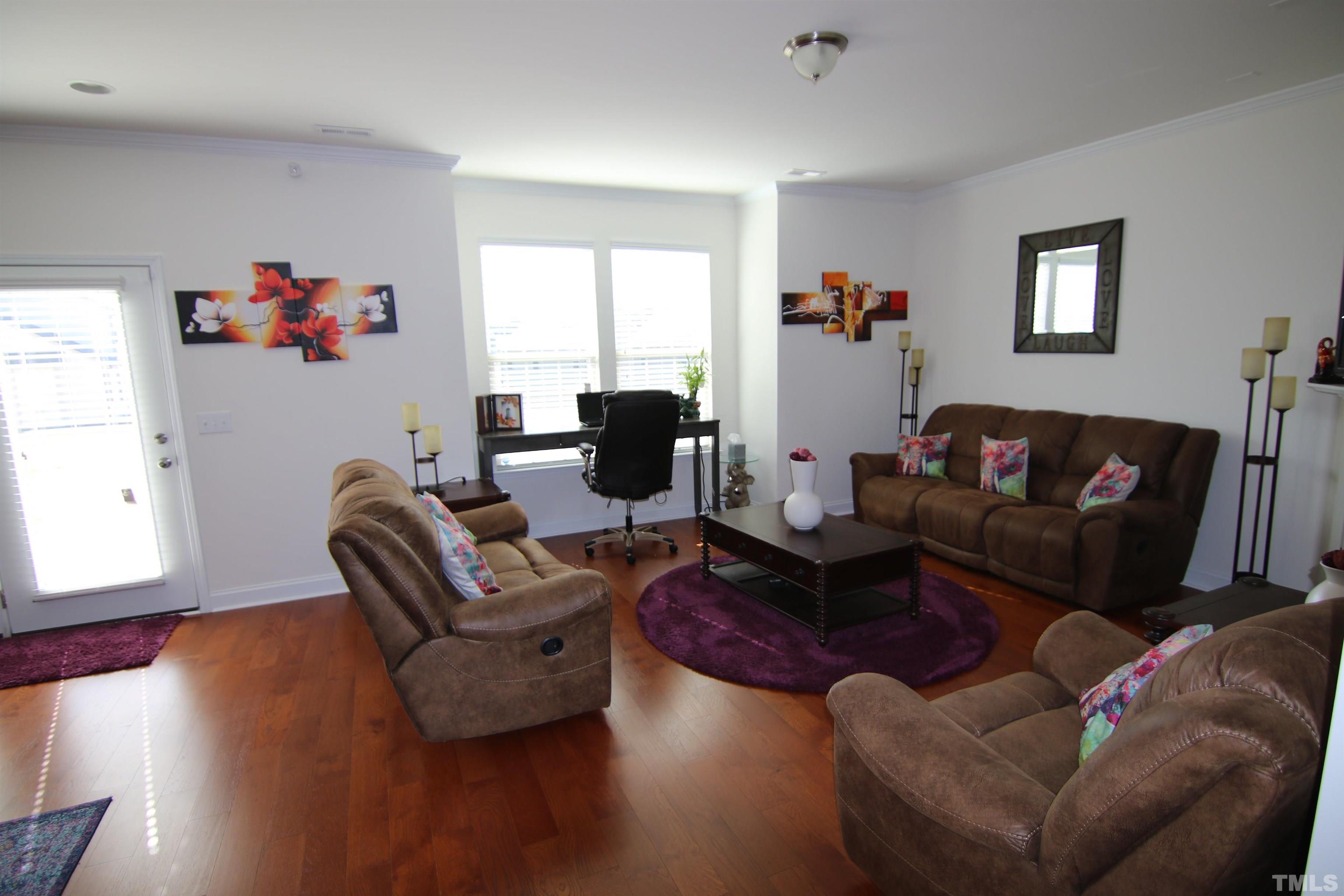 3216 Revelation Street Raleigh, NC 27610 - Photo 8 of 23 a living room with furniture and a wooden floor