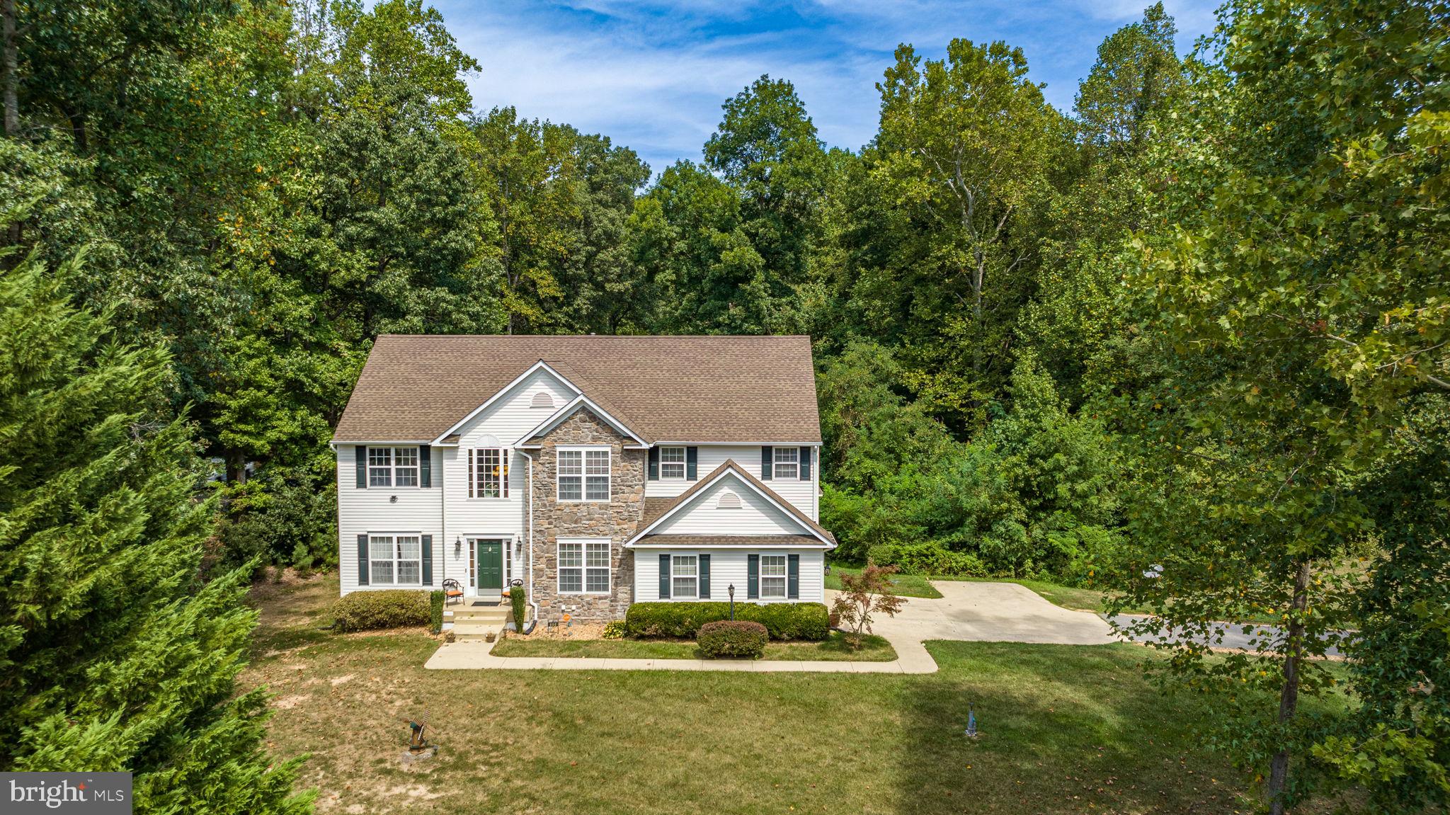 6904 North Stuart Road King George, VA 22485 - Photo 1 of 47 a front view of a house with a yard and trees