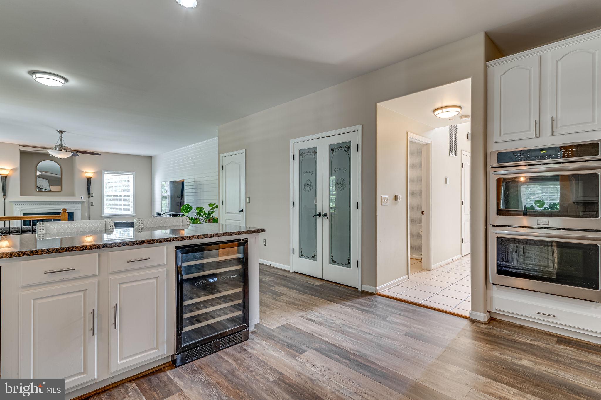 6904 North Stuart Road King George, VA 22485 - Photo 13 of 47 a kitchen with granite countertop a refrigerator and a stove top oven