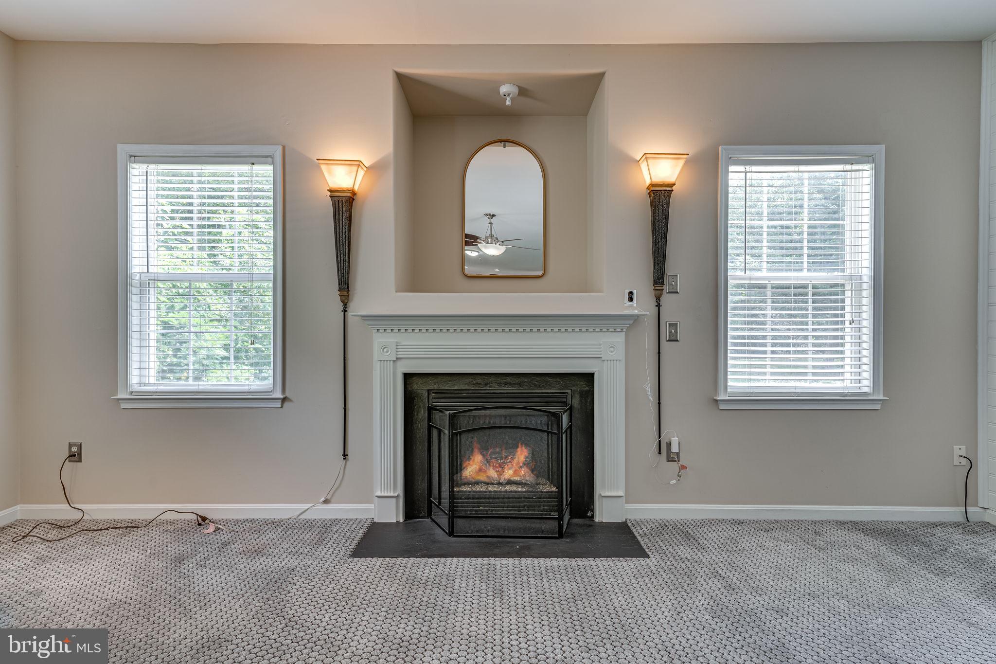 6904 North Stuart Road King George, VA 22485 - Photo 15 of 47 a living room with a fireplace and a window