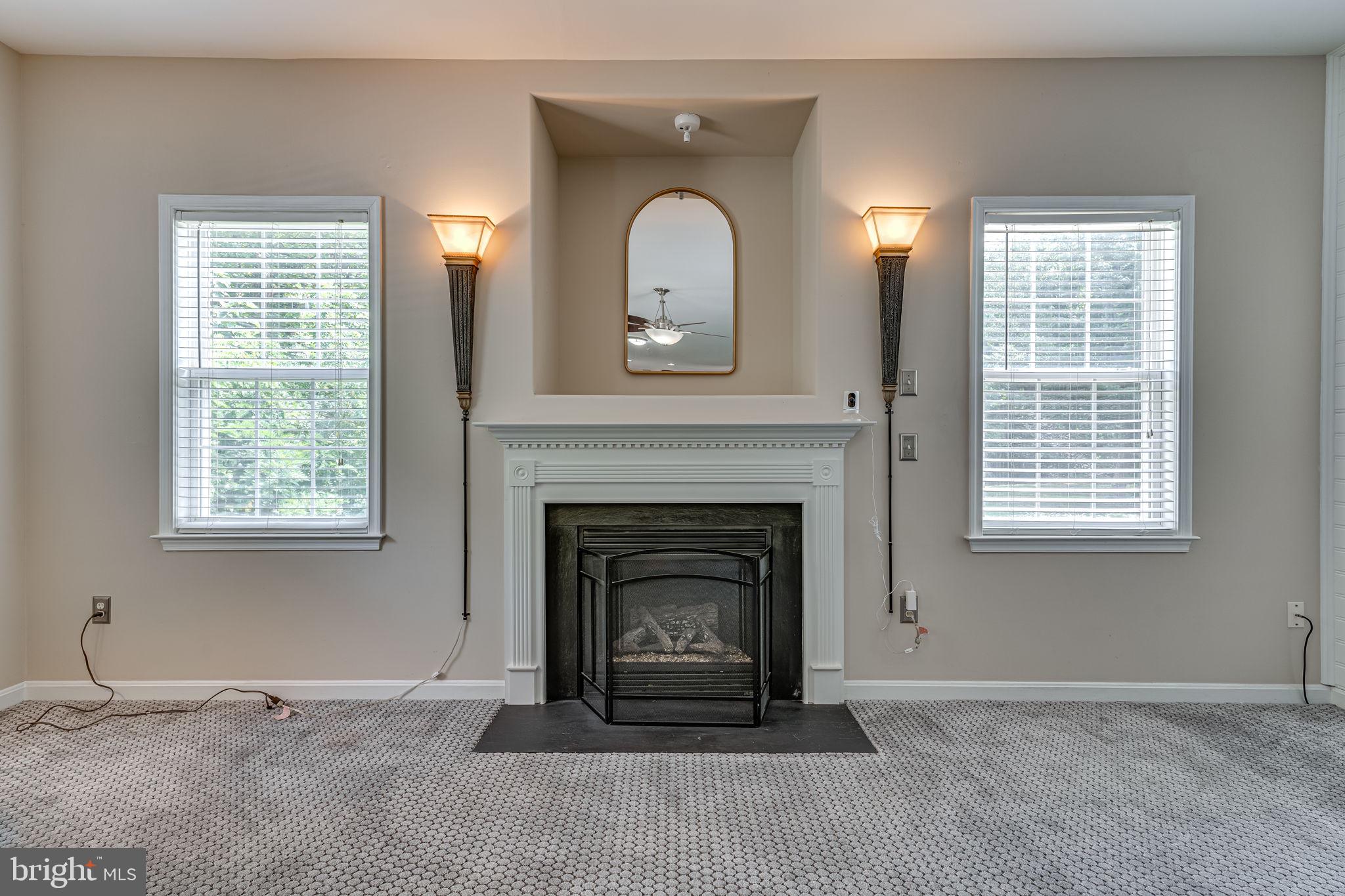6904 North Stuart Road King George, VA 22485 - Photo 16 of 47 a living room with a fireplace and a window