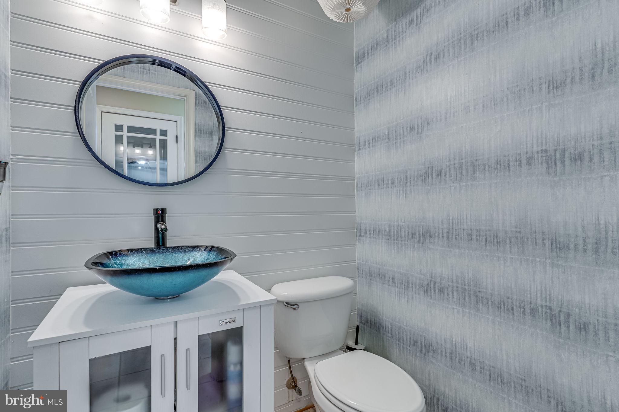 6904 North Stuart Road King George, VA 22485 - Photo 17 of 47 a bathroom with a toilet a sink and a mirror
