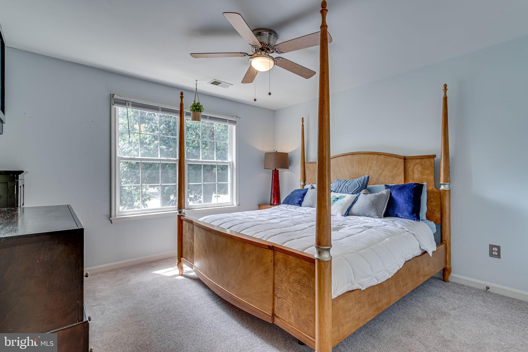 6904 North Stuart Road King George, VA 22485 - Photo 19 of 47 a bed room with a bed and a chandelier